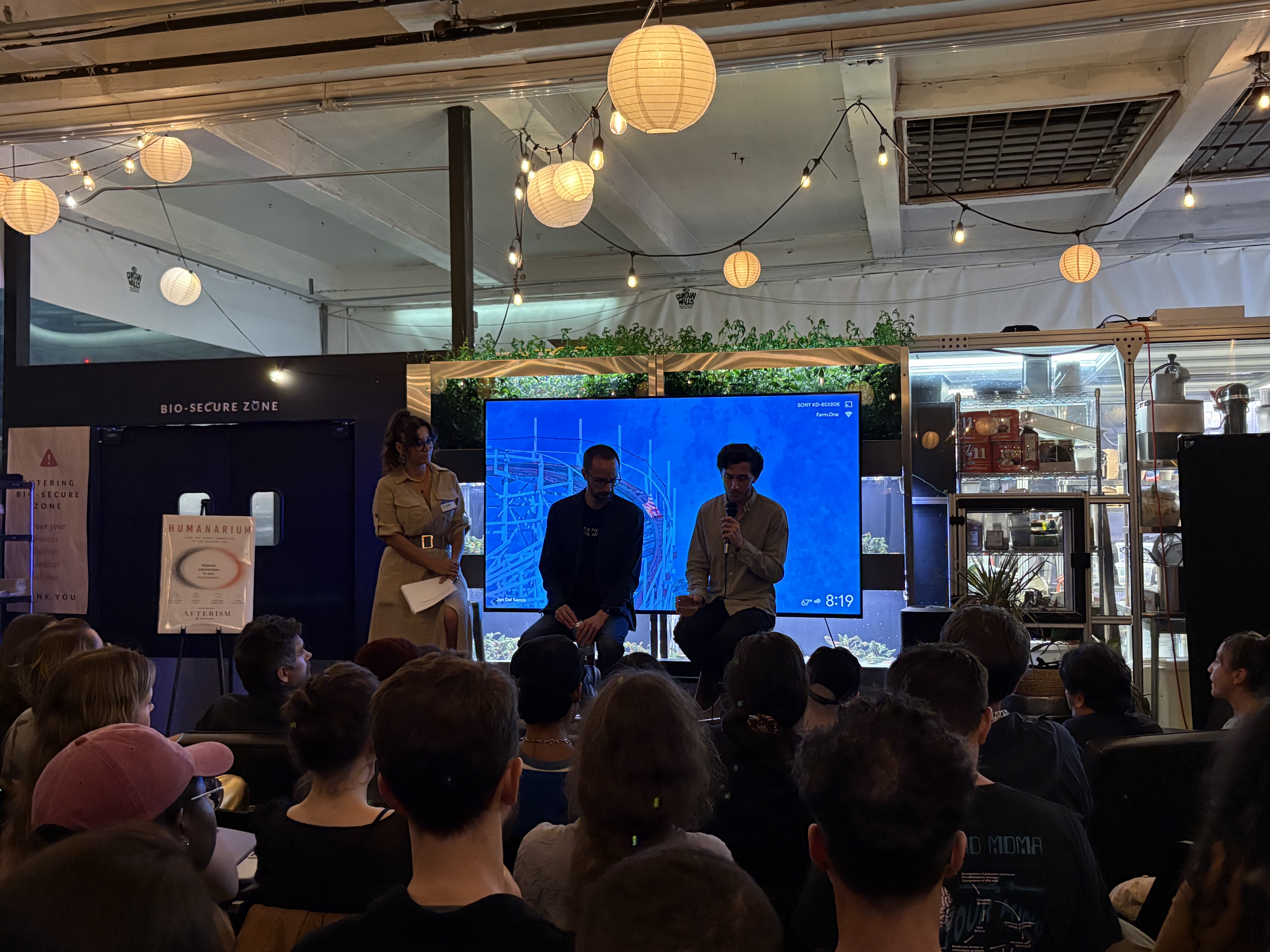 Jeff Sebo (center) and Cameron Berg (right) speak with attendees following the Humanarium screening of "AM I?." / Source: Humanarium (EZ Newswire)