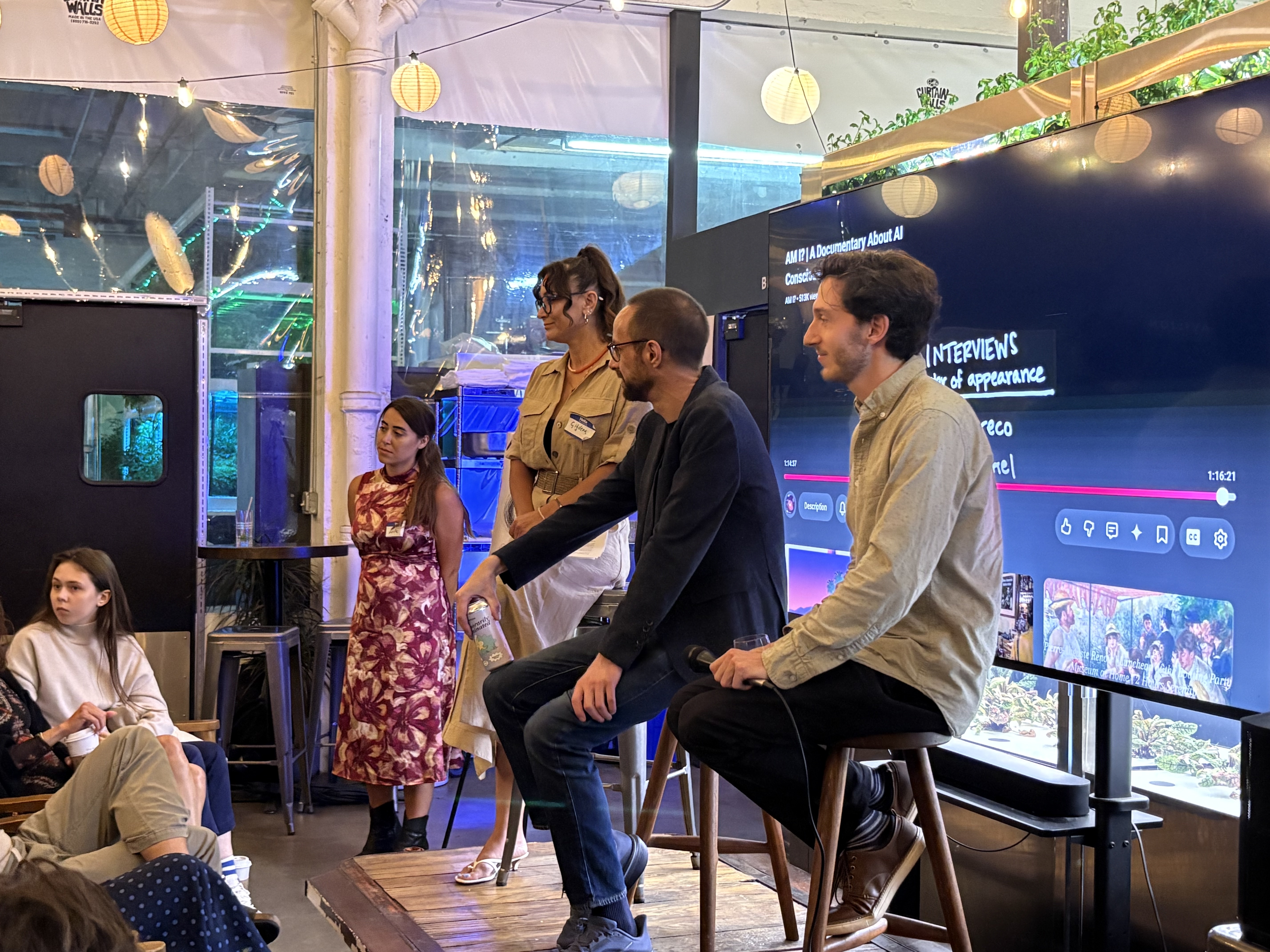 Jeff Sebo (center) and Cameron Berg (right) speak with attendees following the Humanarium screening of "AM I?." / Source: Humanarium (EZ Newswire)